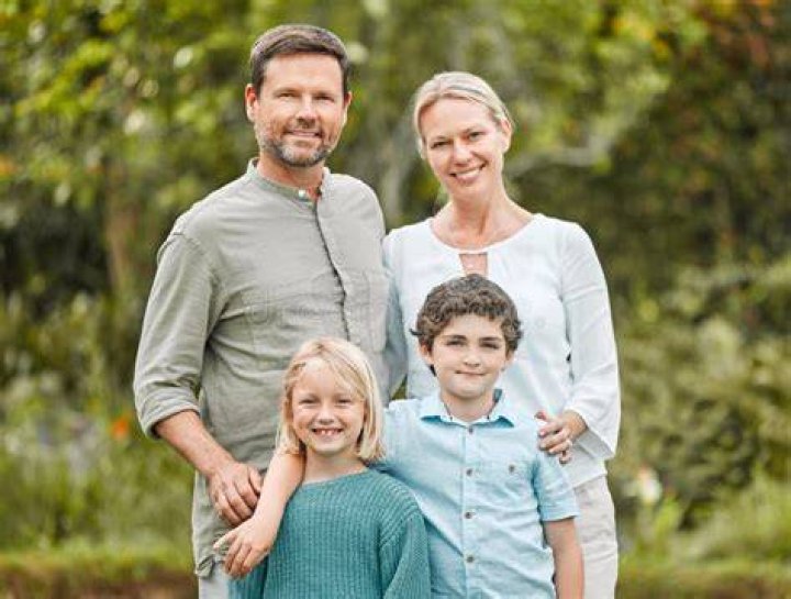 A couple and their children having a lovely time on the beach | Source: Shutterstock