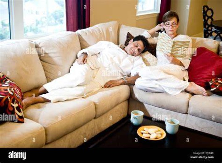 A couple lounging on a couch | Source: Shutterstock