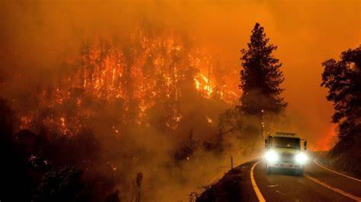 A firetruck drives along California Highway 96 as the McKinney Fire burns in Klamath National Forest, California, on Saturday