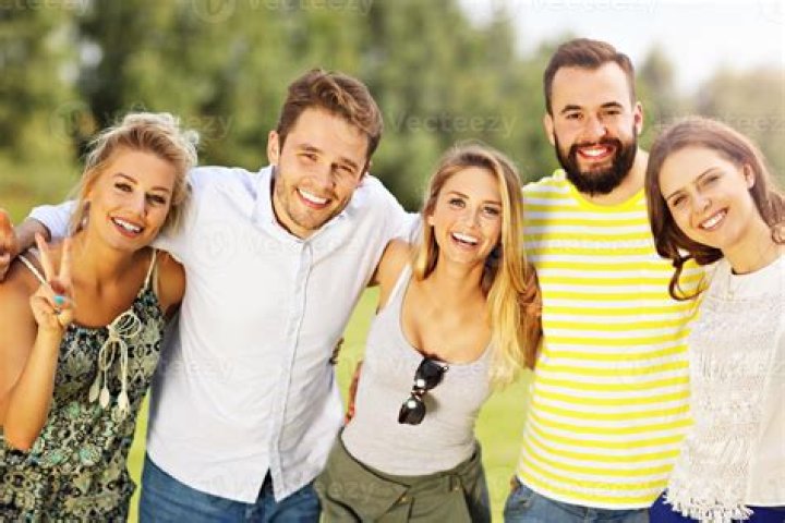 A group of friends is pictured raising toasts at a party | Source: Shutterstock