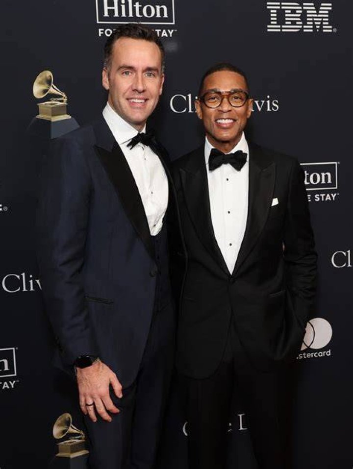 A photo of Tim Malone, Don Lemon, and their dogs | Photo: