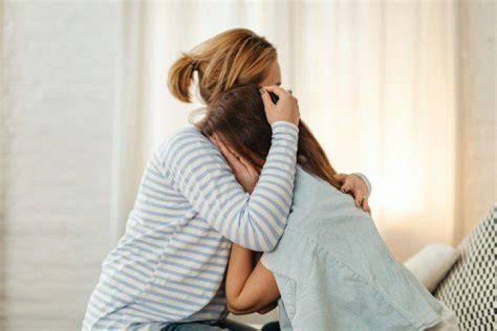 A woman comforting a crying child | Source: Shutterstock