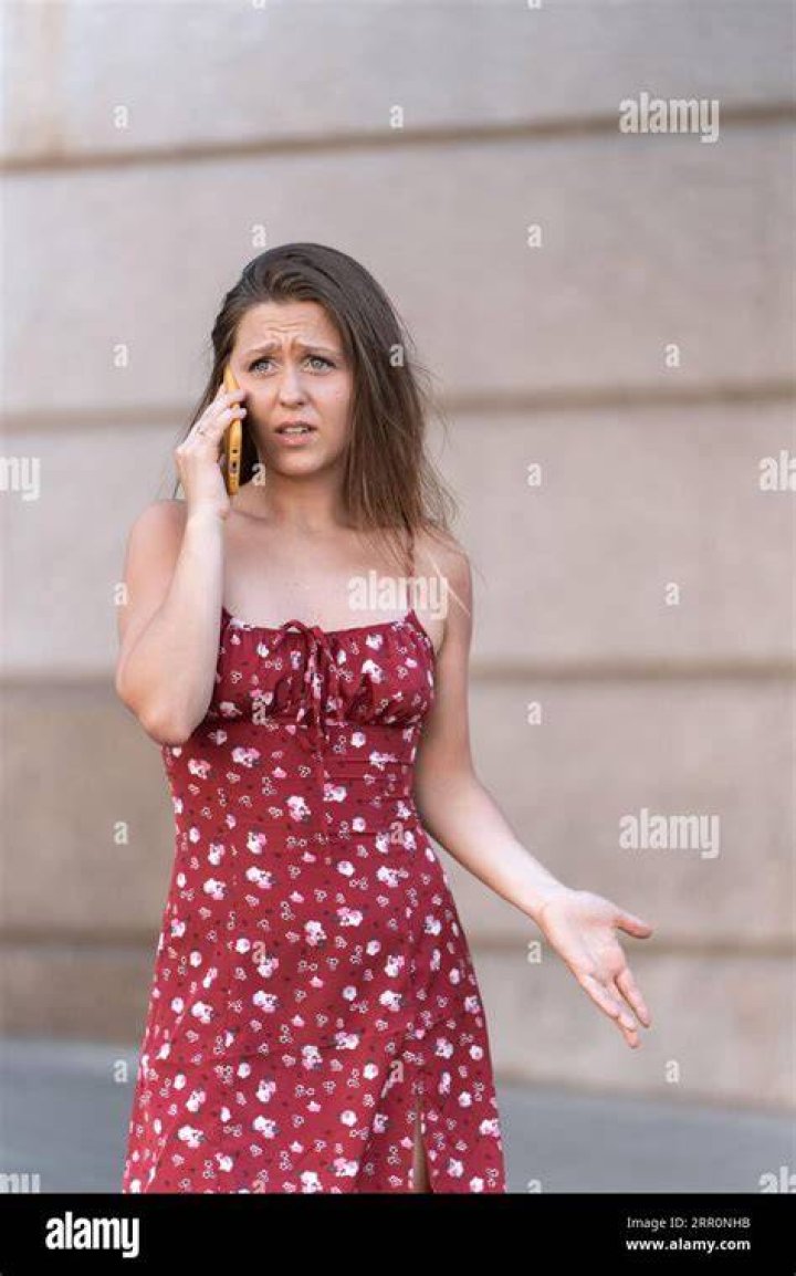 A woman looks upset while sitting in front of a man. | Source: Shutterstock