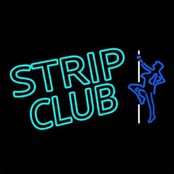 A worn Strip Club sign. | Source: Shutterstock.