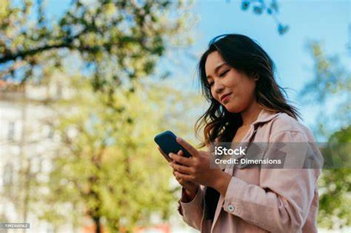 A young woman using her laptop in her bedroom | Source: Shutterstock