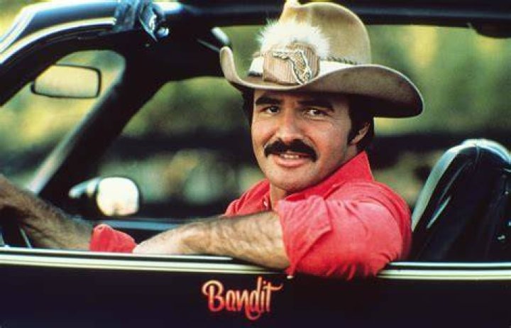 Actor Burt Reynolds as Bandit and Sally Field as Carrie in the comedy film "Smokey and the Bandit" on January 1, 1977 | Source: Getty Images