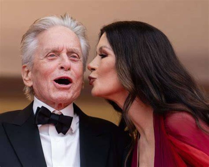 Actors Michael Douglas and Catherine Zeta-Jones and their son Dylan Douglas pose for a photo on the grid before the F1 Grand Prix of Great Britain at Silverstone | Photo: Getty Images