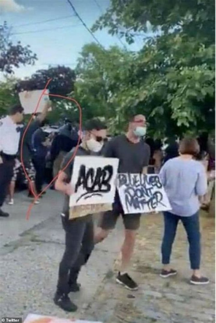 Amato (above, middle) was pictured holding an ACAB sign at a BLM protest of a Back the Blue rally in the Bronx in 2020. ACAB stands for 'All Cops Are B*****rds'