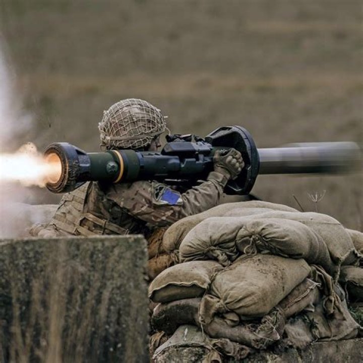 An NLAW missile is launched from the building window at a passing Russian tank, destined to hit its top rear, one of the most vulnerable parts of a tank