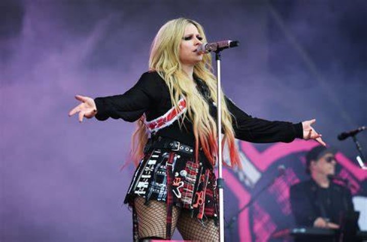 Avril Lavigne Stage Crashed by Topless Protester