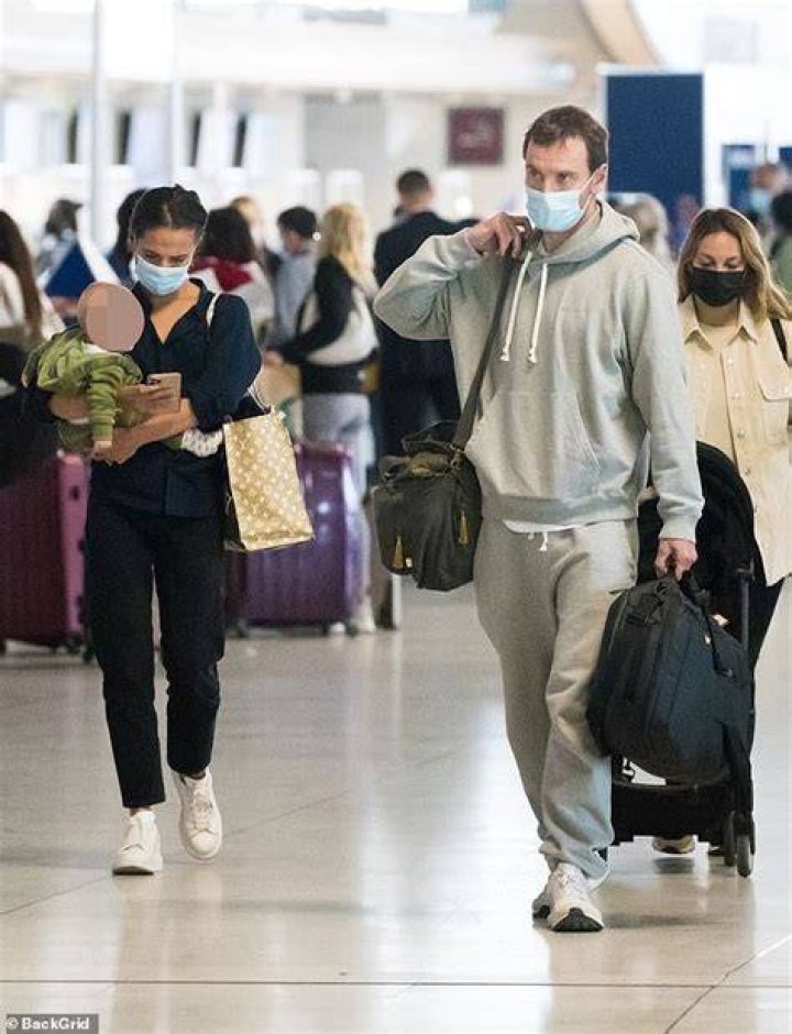 Baggage: Micheal toted two small bags while Alicia held a large Louis Vuitton bag and the baby