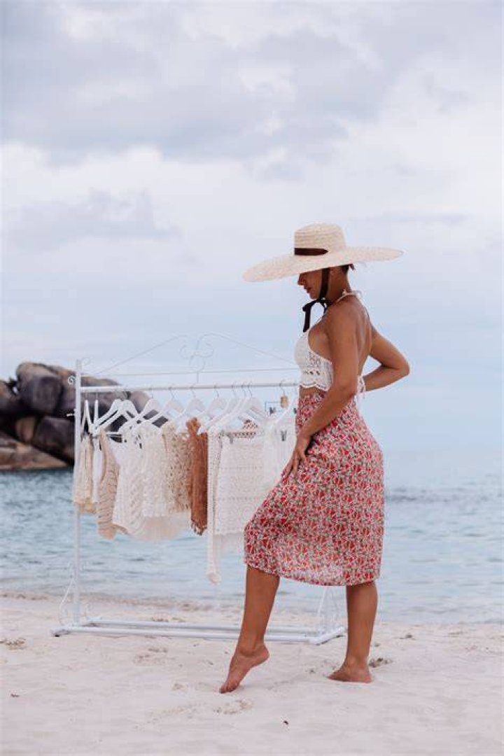 Beach wear: With the sun glaring down, the Virginia native opted to wear shorts with a cropped plaid shirt and a baseball cap