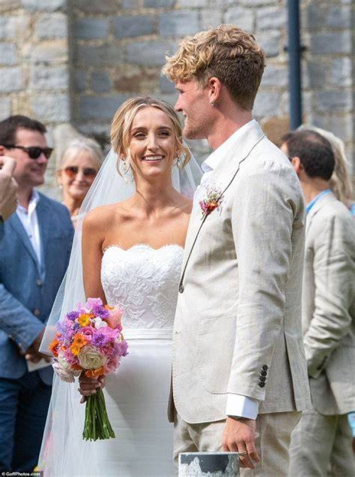 Beaming: The newlyweds looked every inch the happy couple as they waved to onlookers while leaving the church
