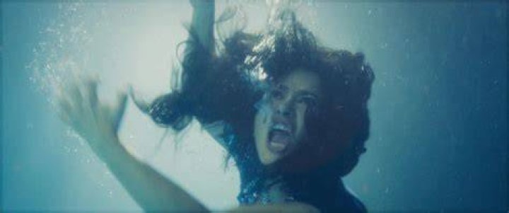 Braving the water! Salma Hayek, 55, showed off her famed physique while taking a very chilled ocean dip which caused her to wince in pain at first