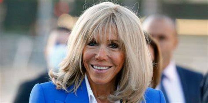 Brigitte Macron, 68, teamed the beige two-piece with a white organza lace blouse and chic pearl espadrilles
