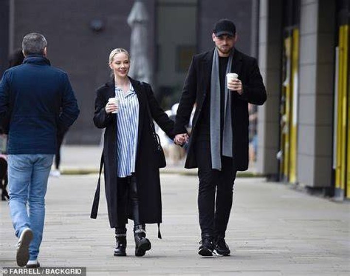 Bundled-up: Jess looked stylish wearing a longline striped blue and white shirt which she wore over a pair of tight leather-look leggings