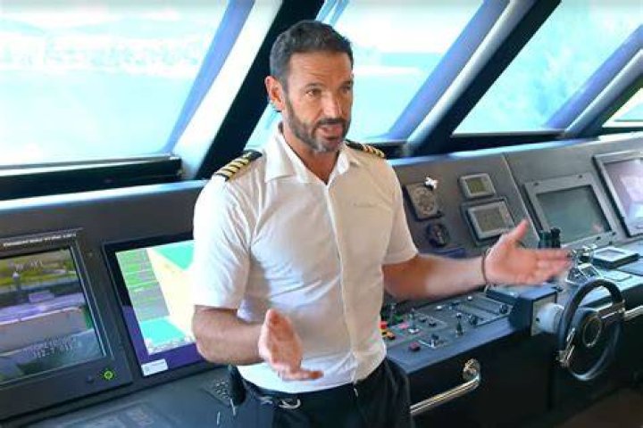 Captain Jason Chambers talks to a crew member. Chef Ryan McKeown listens to direction in the 'Below Deck Down Under' kitchen