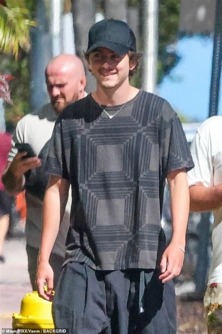 Casual: The actor donned a white T-shirt and grey tracksuit bottoms as he pushed the pram