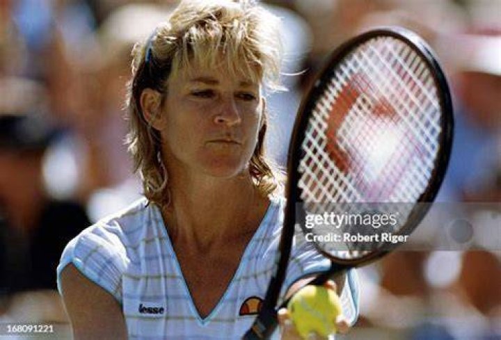 Chris Evert during the men's quarter finals at Wimbledon with Andy Mills and young son on 5 Jul 1995. | Source: Getty Images
