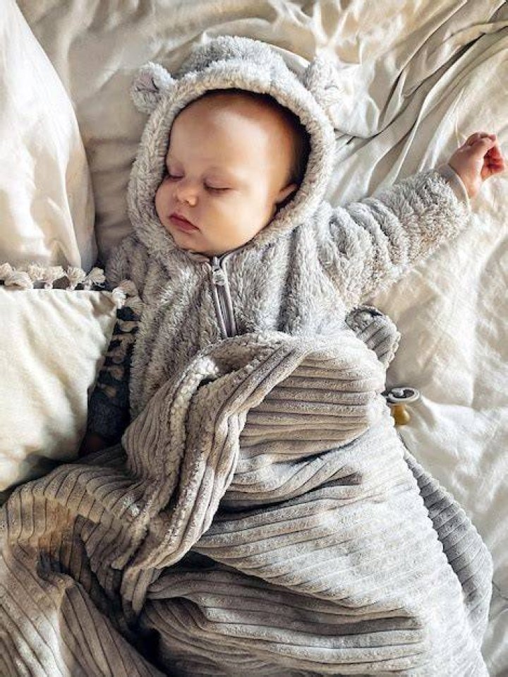 Cosy: The baby was dressed in a green camouflage onesie and white socks