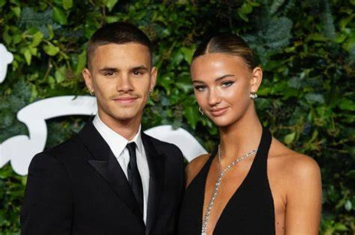 Cute couple: Romeo Beckham and Mia Regan cosied up for some snaps