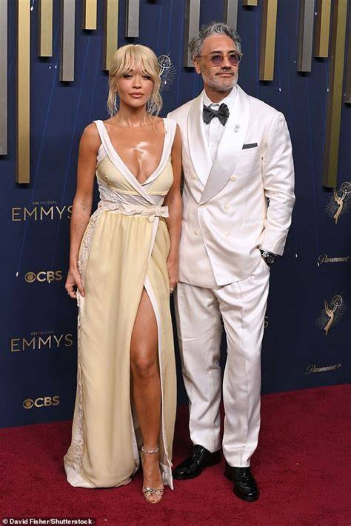 Dapper: Taika cut a very dashing figure in a navy blue fitted suit, layered over a white shirt with a black bowtie, with a crystal pendant worn around his neck