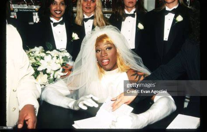 Dennis Rodman signs his autobiography August 21, 1996 in New York City. Rodman arrived in a horse-drawn carriage dressed in a wedding gown to launch his new book called "Bad as I Wanna Be." | Source: Getty Images