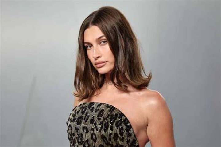 Different look: Later, her brunette locks were slicked back over her ears
