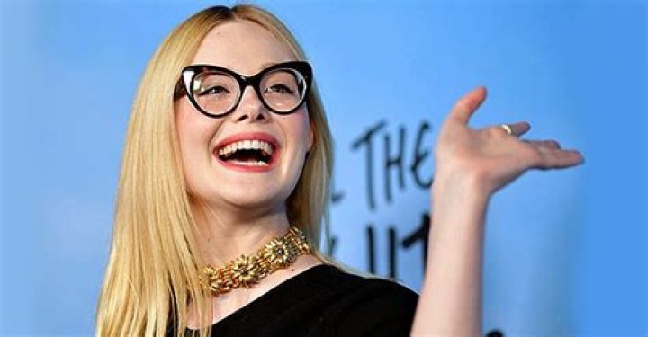 Elle Fanning, 23, Poses on Her Bed in Flirty off-Shoulder Dress in a Photo Shoot for W Magazine