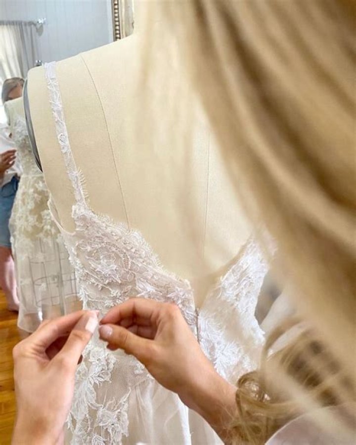 Finishing touches: The stunning gown was teamed with a cathedral-length raw edged veil which complimented the dress perfectly