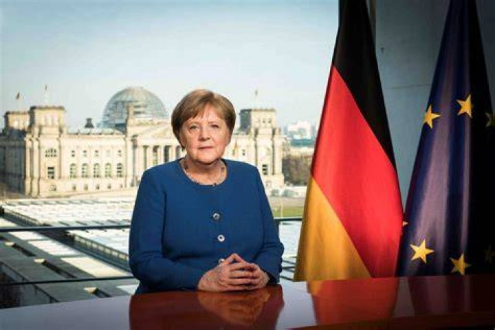 German Chancellor Angela Merkel deliberates with US president Donald Trump on the sidelines of the official agenda on the second day of the G7 summit on June 9, 2018 in Charlevoix, Canada, as Abe looks on