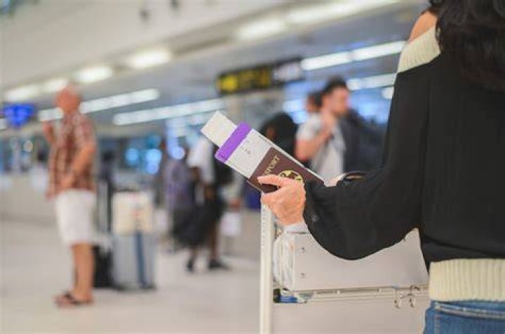Girl holding passports and boarding pass | Source: Shutterstock