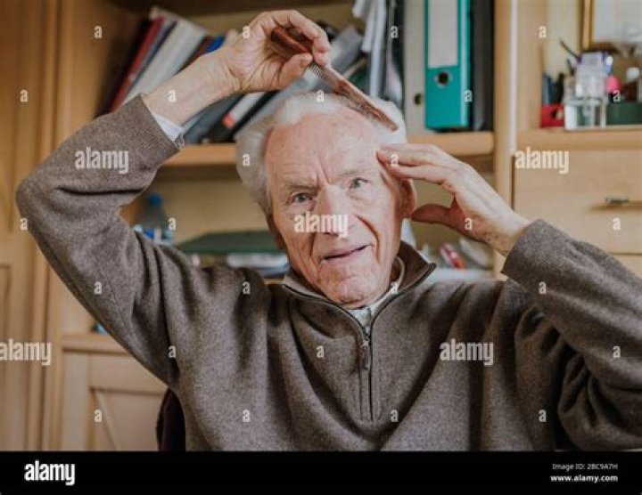 Grandfather combs his hair and gets ready to visit his sickly wife. | Source: