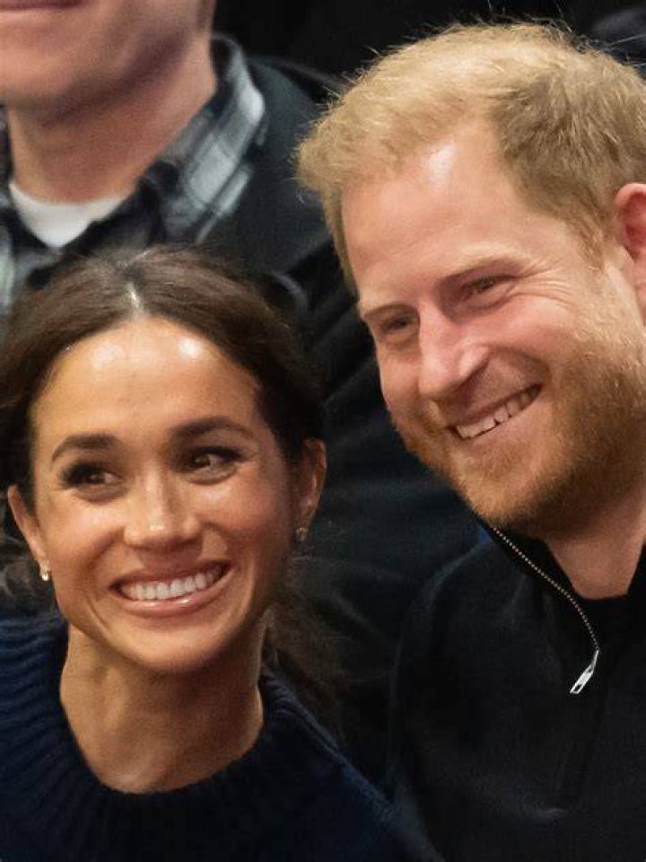 Harry and Meghan smile as their walk through their Californian estate in a photoshoot branded 'awkward' and 'photoshopped'