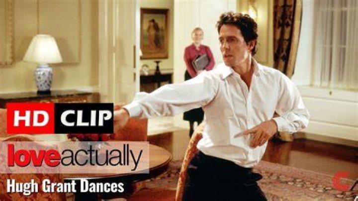 Hugh Grant dancing down the stairs in the film "Love Actually." | Source: YouTube/Movieclips.