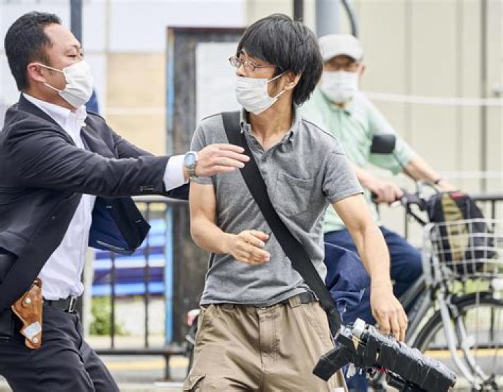 Killer Tetsuya Yamagami used a home-made shotgun which is clearly visible in the bottom right of the shot a moment as the first security official lunges in to disarm and retrain him