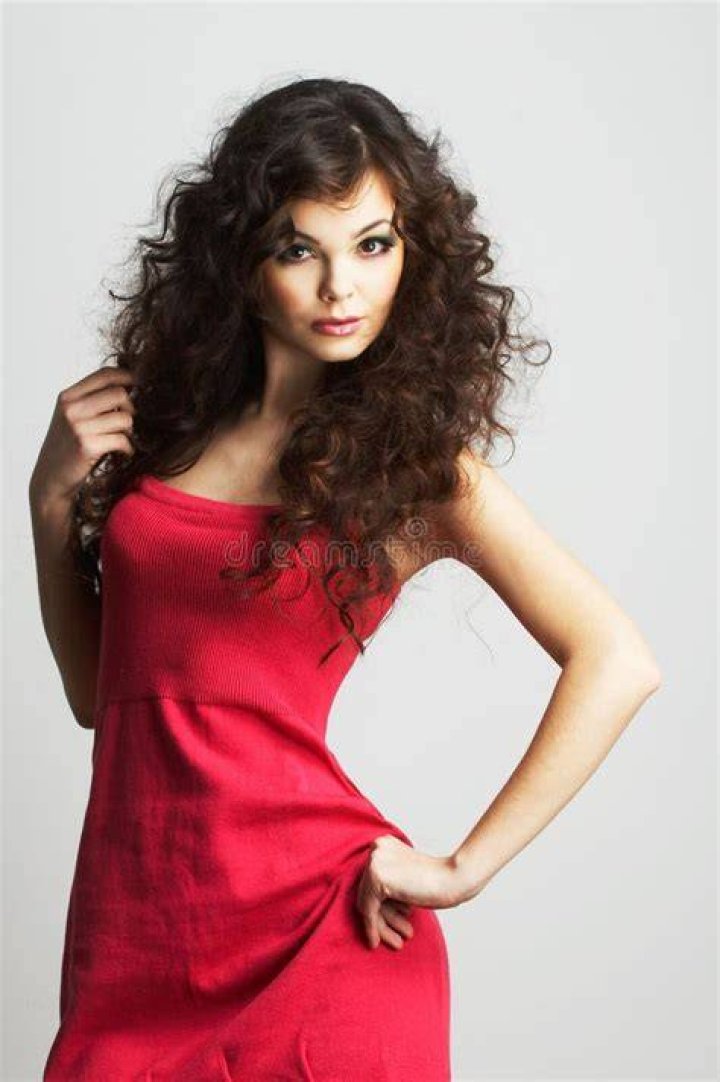 Lady in red: Her brunette locks were swept up in an beautiful braided bun, while she sported a crown made of red roses on top of her head