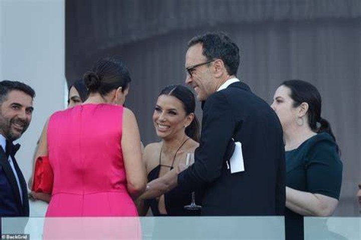 Laughing: Eva, who attended the wedding with her businessman husband José, chatted to guests as she enjoyed a cocktail on the balconny