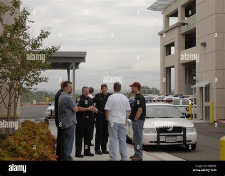 Law enforcement wait outside after a deadly shooting on Sunday. Photo / AP
