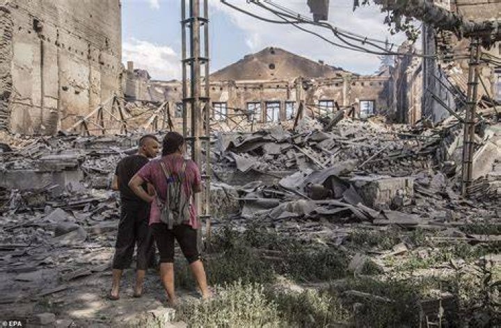 Locals look at destroyed buildings in Lysychansk after heavy fighting in the Luhansk area. Capturing Severodonetsk and its twin city of Lysychansk, Severodonetsk's sister city across the Donets river, would give the Russians control of Lugansk, and allow them to push further into the wider Donbas