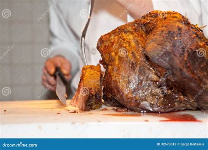 Meat being carved up for a family dinner | Source: Pexels