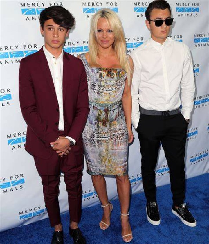 Pamela Anderson and her sons Brandon and Dylan Lee at the Saint Laurent show in Hollywood in 2016 | Source: Getty Images