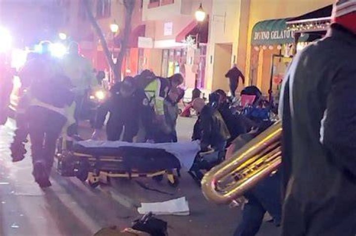 Passersby attend to injured people after a car plowed through a crowd at a holiday parade in Waukesha, Wisconsin