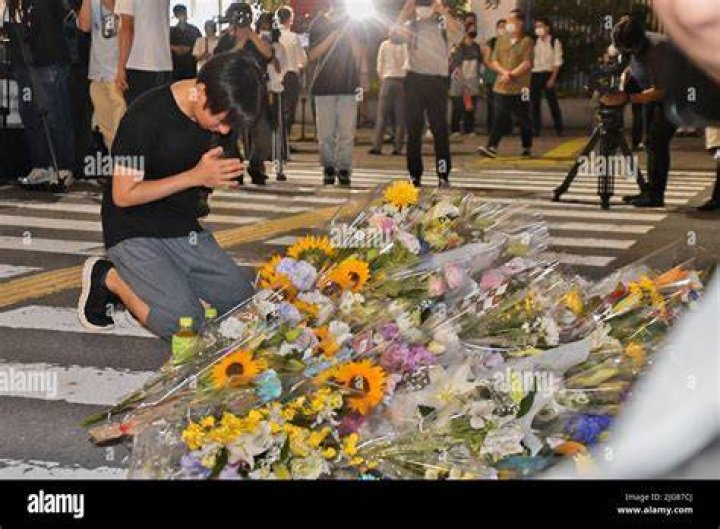 Peoples offer flowers and prays laid at the site where late former Japanese Prime Minister Shinzo Abe was shot
