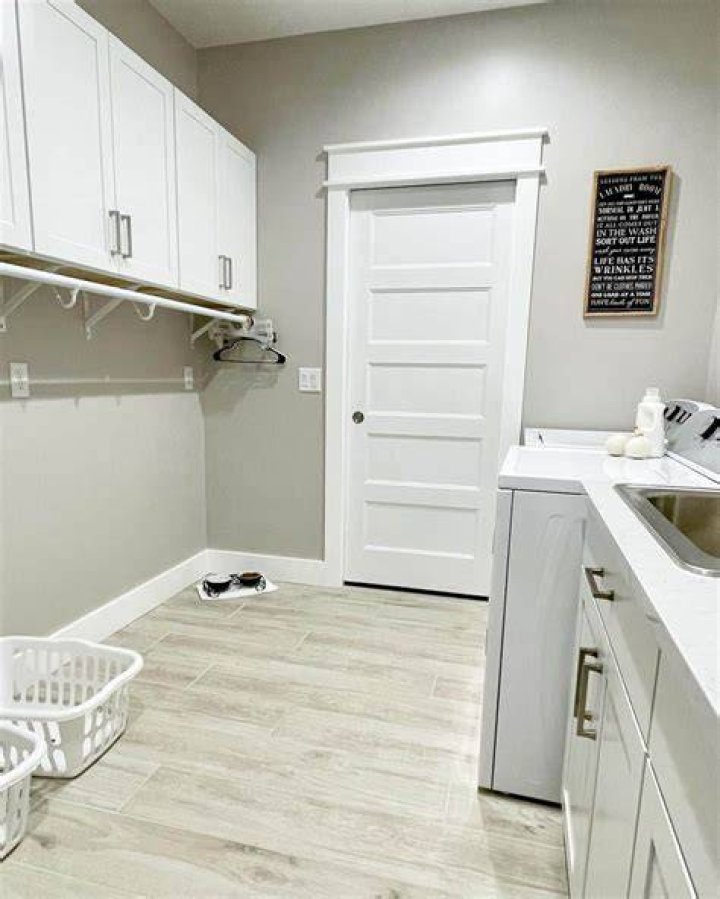 Plenty of space: The laundry room comes complete with a washer, dryer, sink, and plenty of cabinets