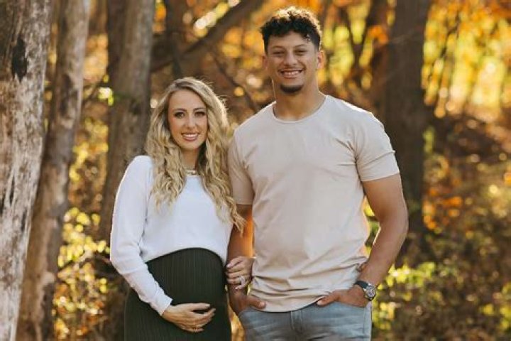 Pregnant: Brittany's baby bump could be seen beneath her elegant gown as she walked with her daughter at the wedding. She is expecting her fourth child