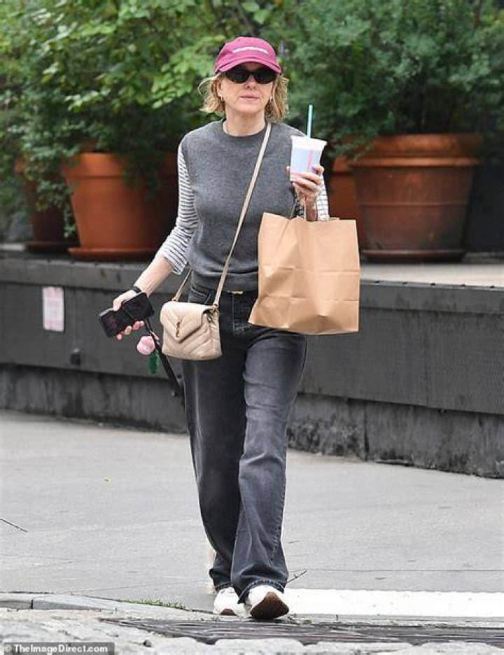 Relaxed: She looked effortlessly chic in black jeans and a navy shirt which buttoned down the middle