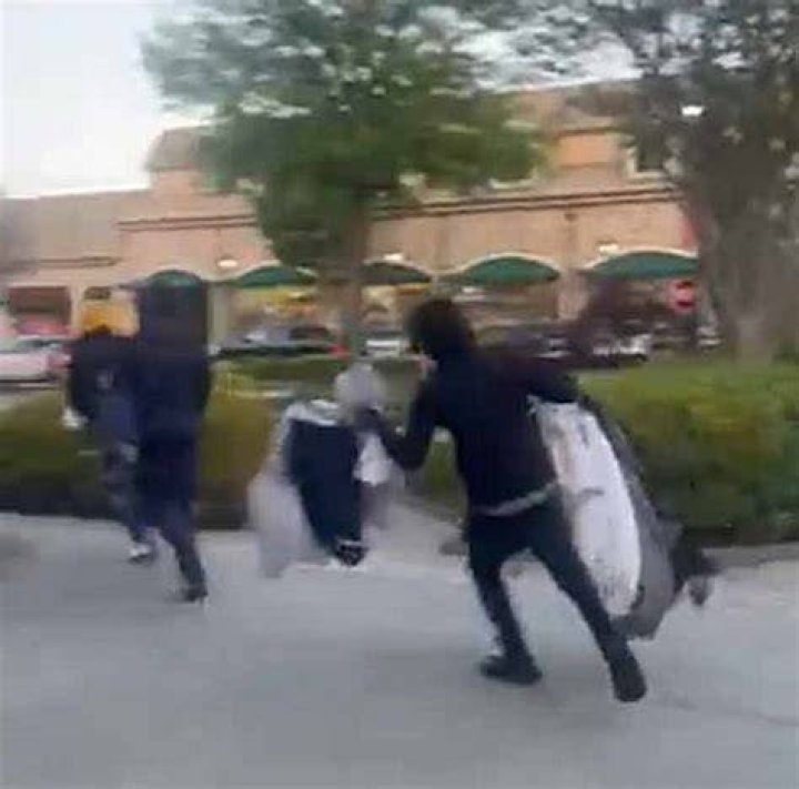 Shocking footage shows masked robbers taking merchandise from displays near the front of the Lululemon store in Atlanta, before rushing out to their getaway car
