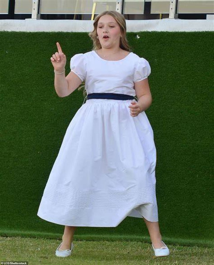 Special day: Harper looked lovely in a white gown and matching flats as she danced on the lawn while attending her older brother's wedding in Miami on Saturday