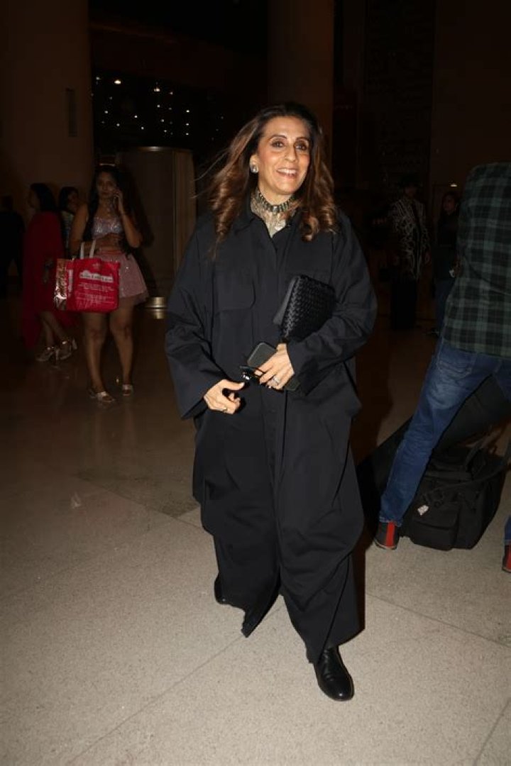 Stylish: The actress stunned in an all-black ensemble that consisted of a black skirt, with a long slit along the left, a matching crop top and long jacket